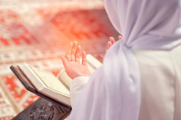 A Muslim girl reading Quran